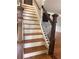 Staircase with hardwood treads and black metal spindles leading upstairs at 1055 Worthington Hills Dr, Roswell, GA 30076