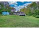 Exterior shot of backyard with a deck and outbuilding at 160 Riverbrooke Trl, Covington, GA 30016