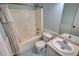 Functional bathroom featuring a tub/shower combo, toilet, patterned flooring, and vanity with a sink at 160 Riverbrooke Trl, Covington, GA 30016
