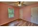 Bedroom with laminate flooring, ceiling fan and a large window at 160 Riverbrooke Trl, Covington, GA 30016