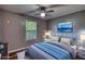 Comfortable bedroom featuring soft lighting, hardwood floors, a large window, and calming decor at 160 Riverbrooke Trl, Covington, GA 30016