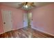 Bedroom with laminate flooring, ceiling fan and neutral paint at 160 Riverbrooke Trl, Covington, GA 30016
