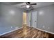 Neutral bedroom with ample space, featuring hardwood floors, ceiling fan, and two large closets at 160 Riverbrooke Trl, Covington, GA 30016
