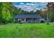 Charming single-story home with a covered porch, and lush landscaping at 160 Riverbrooke Trl, Covington, GA 30016