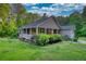 Single-story home featuring a covered front porch, well-maintained landscaping, and a side garage at 160 Riverbrooke Trl, Covington, GA 30016