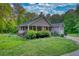 Beautiful single-story home featuring a charming covered porch and well-manicured lawn at 160 Riverbrooke Trl, Covington, GA 30016
