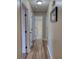 Hallway features laminate flooring and doorways leading to various rooms at 160 Riverbrooke Trl, Covington, GA 30016