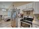 Bright kitchen with stainless steel appliances and adjacent living space at 160 Riverbrooke Trl, Covington, GA 30016