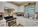 Bright kitchen featuring stainless steel appliances and white cabinets at 160 Riverbrooke Trl, Covington, GA 30016
