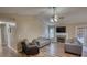 Inviting living room featuring a stone fireplace, hardwood flooring, and neutral walls at 160 Riverbrooke Trl, Covington, GA 30016