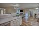 Open layout connecting kitchen and living area with hardwood floors at 160 Riverbrooke Trl, Covington, GA 30016