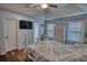 Bedroom features a trey ceiling, ceiling fan and a view to the en suite bathroom at 160 Riverbrooke Trl, Covington, GA 30016