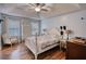 Bedroom with a ceiling fan, ample light, and laminate flooring at 160 Riverbrooke Trl, Covington, GA 30016