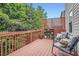 Relaxing deck area with outdoor seating and potted plants, surrounded by lush greenery at 1928 Stancrest Nw Trce, Kennesaw, GA 30152