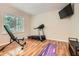 Well-lit exercise room with hardwood floors, a treadmill, and a weight bench near a bright window at 1928 Stancrest Nw Trce, Kennesaw, GA 30152