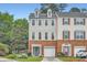 Charming multi-story townhome with brick and siding, offering an attached garage and landscaped front yard at 1928 Stancrest Nw Trce, Kennesaw, GA 30152