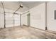 Spacious attached garage featuring ample room for vehicles and storage, plus a service door at 1928 Stancrest Nw Trce, Kennesaw, GA 30152
