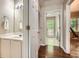 Hallway view showcasing a white vanity, closet space and natural light pouring in from a nearby window at 1928 Stancrest Nw Trce, Kennesaw, GA 30152