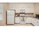 This bright kitchen offers sleek appliances, including a refrigerator, microwave, and oven at 1928 Stancrest Nw Trce, Kennesaw, GA 30152