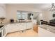 Bright kitchen features white cabinetry, granite countertops, tile backsplash, and an adjacent breakfast nook at 1928 Stancrest Nw Trce, Kennesaw, GA 30152