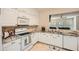 Bright kitchen with white cabinets, tile backsplash, and an open view to the living room at 1928 Stancrest Nw Trce, Kennesaw, GA 30152
