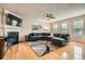 Bright living room with fireplace, hardwood floors, and a large sectional couch at 1928 Stancrest Nw Trce, Kennesaw, GA 30152