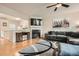 Comfortable living room featuring hardwood floors, a fireplace, and an open view to the kitchen at 1928 Stancrest Nw Trce, Kennesaw, GA 30152