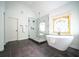 Luxurious bathroom with soaking tub, walk-in shower and stained glass window at 21 Whitegrass Way, Grayson, GA 30017