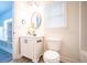 Bright bathroom with white vanity, oval mirror and decorative accents at 21 Whitegrass Way, Grayson, GA 30017