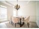 Elegant dining room featuring a modern chandelier and comfortable seating for six at 21 Whitegrass Way, Grayson, GA 30017
