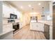 Modern kitchen with white cabinetry, granite countertops, and stainless steel appliances at 21 Whitegrass Way, Grayson, GA 30017