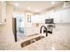 Bright, open kitchen with white cabinets, granite counters, and stainless steel appliances at 21 Whitegrass Way, Grayson, GA 30017