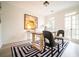 Bright home office with natural light, a modern desk, and a stylish accent rug at 21 Whitegrass Way, Grayson, GA 30017