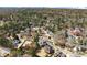 An aerial view showcases a charming neighborhood with mature trees, well-maintained lawns, and picturesque homes at 300 Morganshire Pl, Atlanta, GA 30350