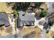Aerial view of house with well manicured landscaping, private driveway, and mature trees in a desirable neighborhood at 300 Morganshire Pl, Atlanta, GA 30350