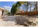 A spacious backyard featuring a patio and a well-maintained lawn, partially enclosed by a wooden fence and mature trees at 300 Morganshire Pl, Atlanta, GA 30350