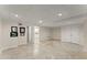 Open basement area with tile flooring, storage, and access to a kitchen at 300 Morganshire Pl, Atlanta, GA 30350