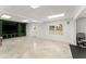 Spacious basement with tile flooring, built-in media center, and natural light at 300 Morganshire Pl, Atlanta, GA 30350