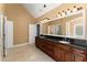 Spacious bathroom featuring dual sinks, granite countertop, and large mirror with attractive lighting at 300 Morganshire Pl, Atlanta, GA 30350