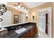 Beautiful bathroom featuring a granite countertop, vessel sink, and decorative lighting at 300 Morganshire Pl, Atlanta, GA 30350