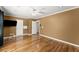 Large, open bedroom featuring hardwood floors, neutral paint, recessed ceiling lights, and direct access to a bathroom at 300 Morganshire Pl, Atlanta, GA 30350