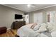 Bedroom showcasing a TV, dresser, and plush bedding at 300 Morganshire Pl, Atlanta, GA 30350