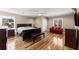 Open main bedroom featuring hardwood floors, a ceiling fan, sitting area, and windows for natural light at 300 Morganshire Pl, Atlanta, GA 30350