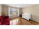 Charming Bedroom featuring hardwood floors, a bright window, and a white crib at 300 Morganshire Pl, Atlanta, GA 30350