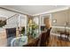 Dining room with decorative glass table and hardwood floors, enhanced by natural light at 300 Morganshire Pl, Atlanta, GA 30350