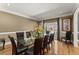Bright dining room with glass table, hardwood floors, and decorative window at 300 Morganshire Pl, Atlanta, GA 30350