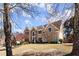 Charming two-story home featuring a stone archway entrance and a manicured front lawn on a sunny day at 300 Morganshire Pl, Atlanta, GA 30350