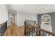 Elegant hallway with hardwood floors and decorative railing at 300 Morganshire Pl, Atlanta, GA 30350
