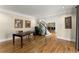 Bright home office with hardwood floors, a staircase, and artwork on the walls at 300 Morganshire Pl, Atlanta, GA 30350