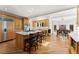 Open kitchen and dining area features a large island, stainless appliances, and hardwood flooring at 300 Morganshire Pl, Atlanta, GA 30350